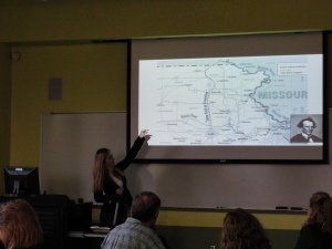 Jessica points to sections of the Underground Railroad and The Manhattan Spur, highlighted on a map of Kansas